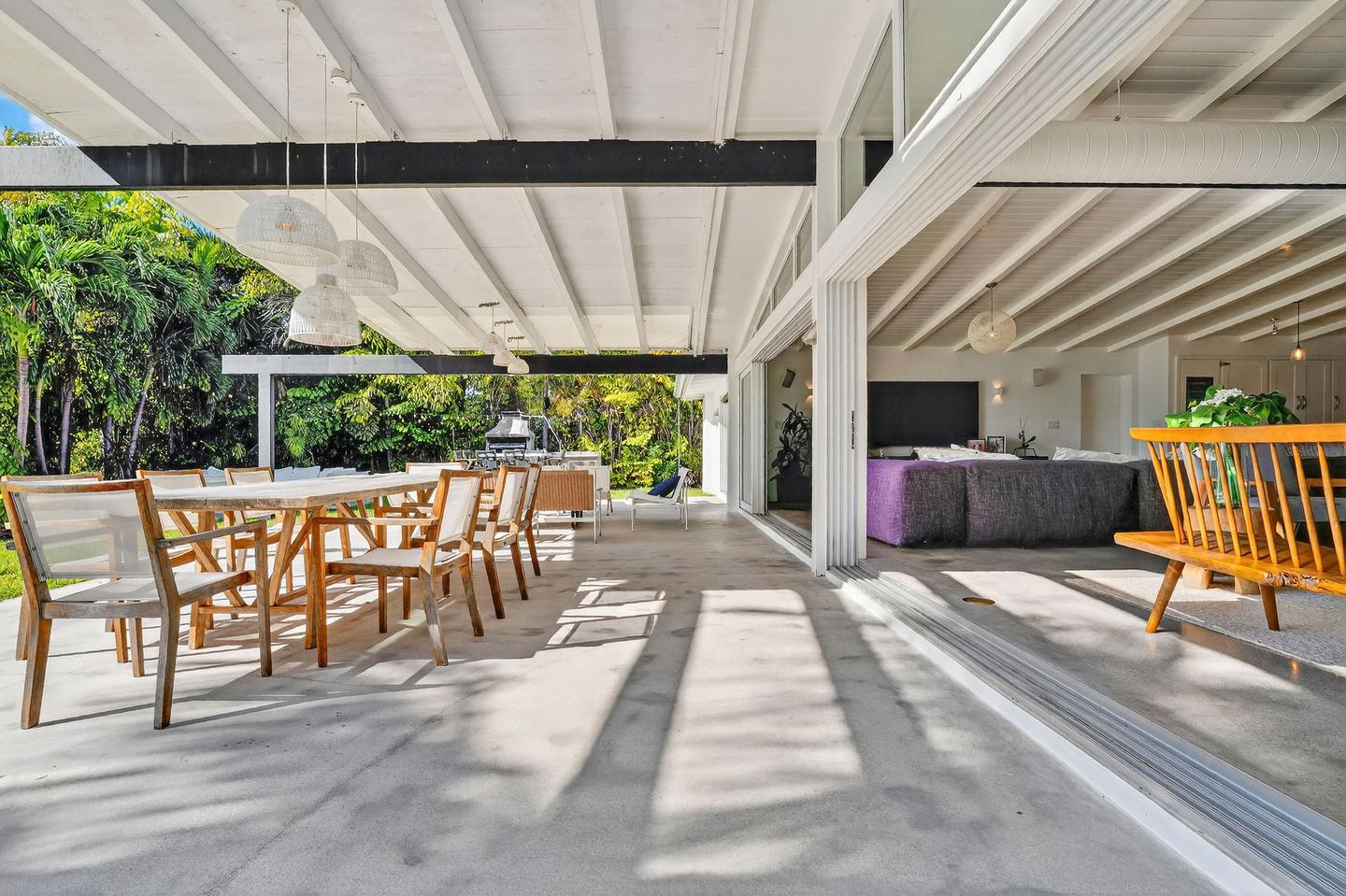 Covered outdoor living and dining area opening to interior