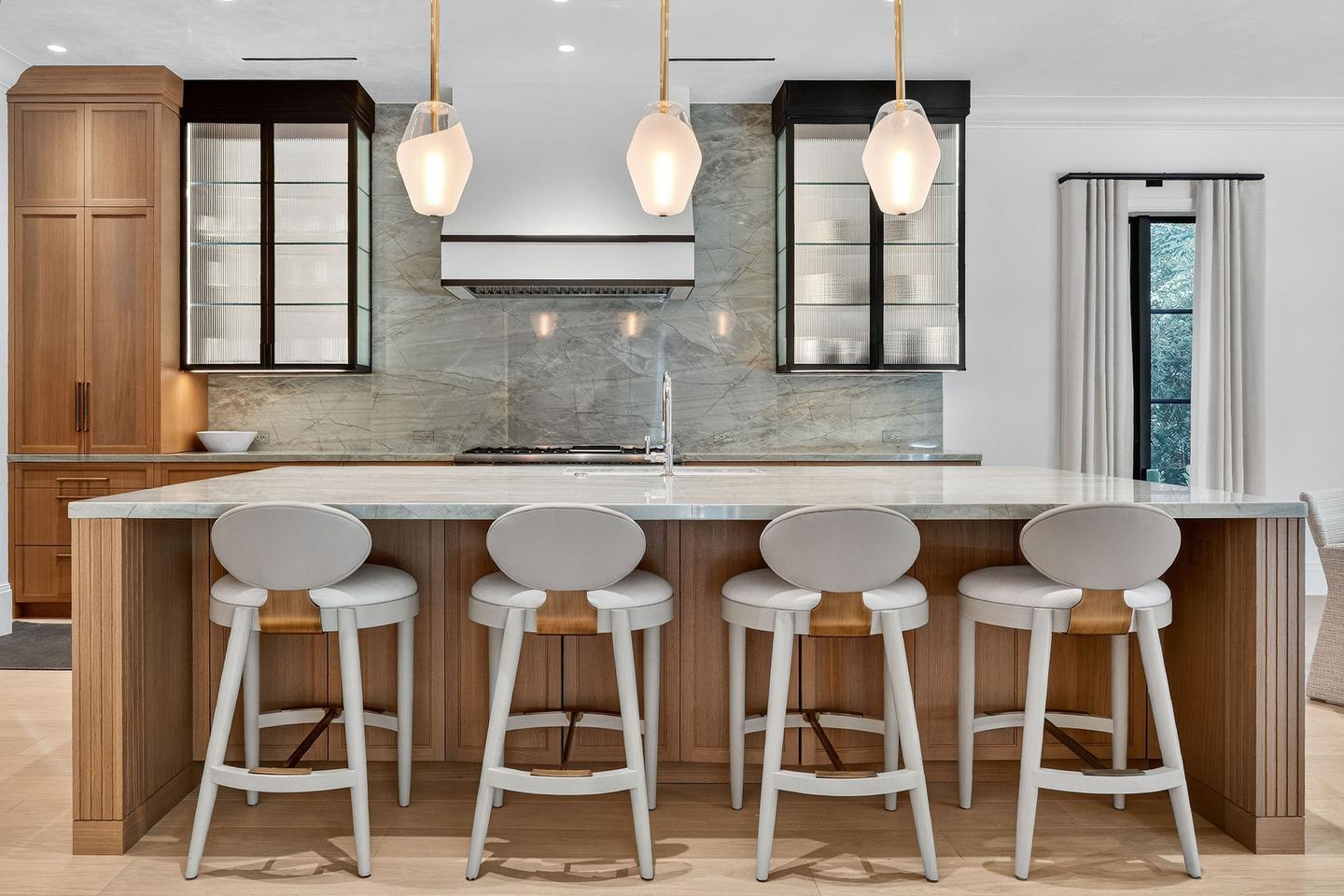 Kitchen with marble island and bar stools