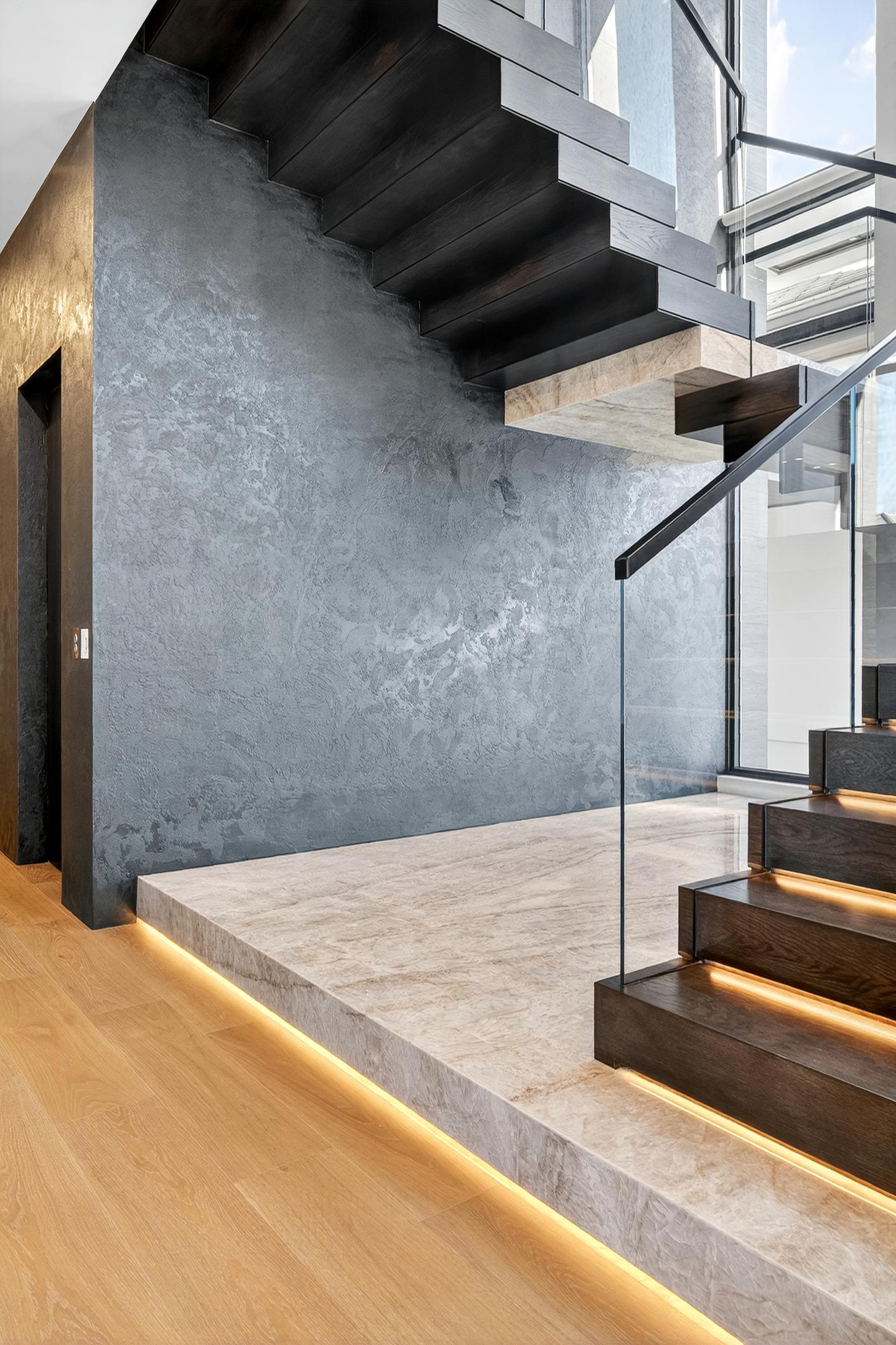 Floating staircase — tighter angle showing dark wall texture and LED risers