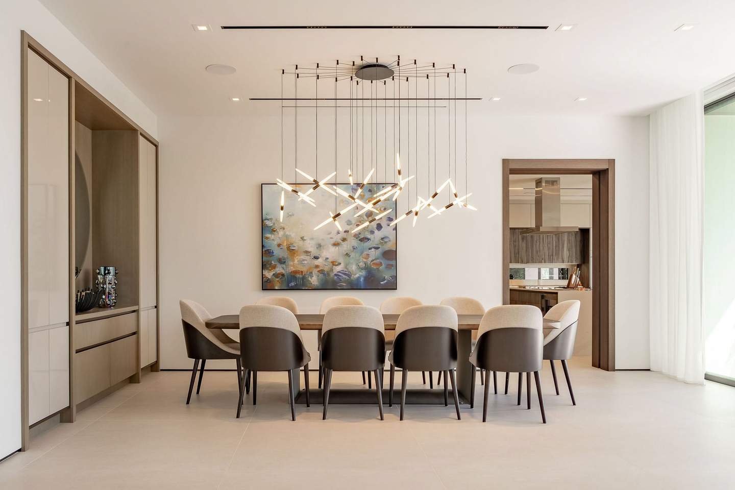 Luxury waterfront living room with floor-to-ceiling windows overlooking Biscayne Bay in Miami