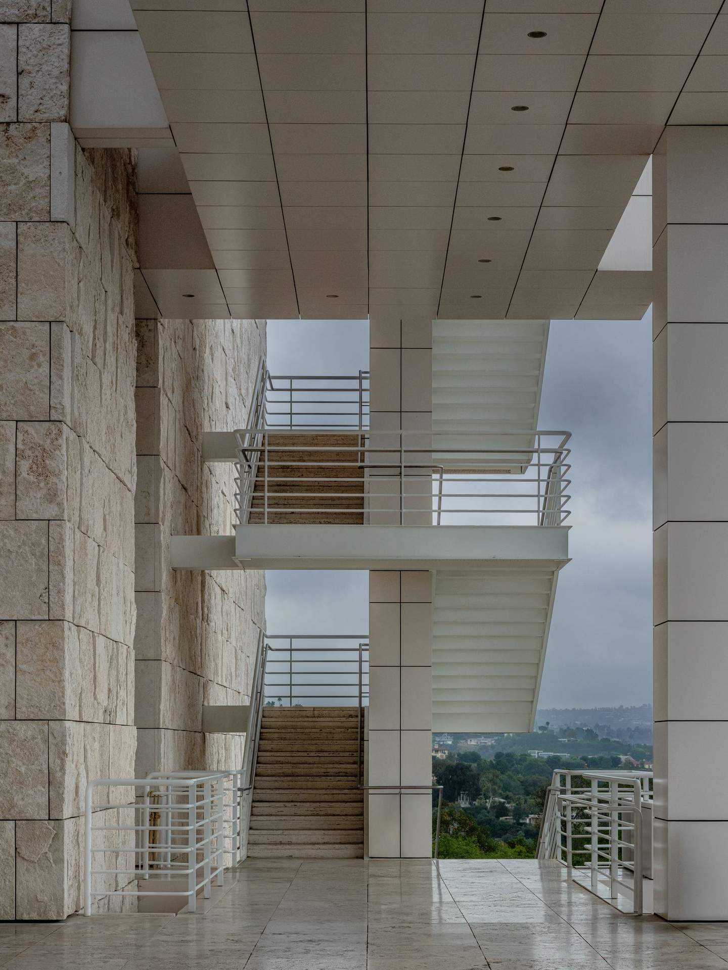 Getty Center exterior staircase framing view to the Los Angeles basin below, travertine cladding grid interrupted by diagonal stair run