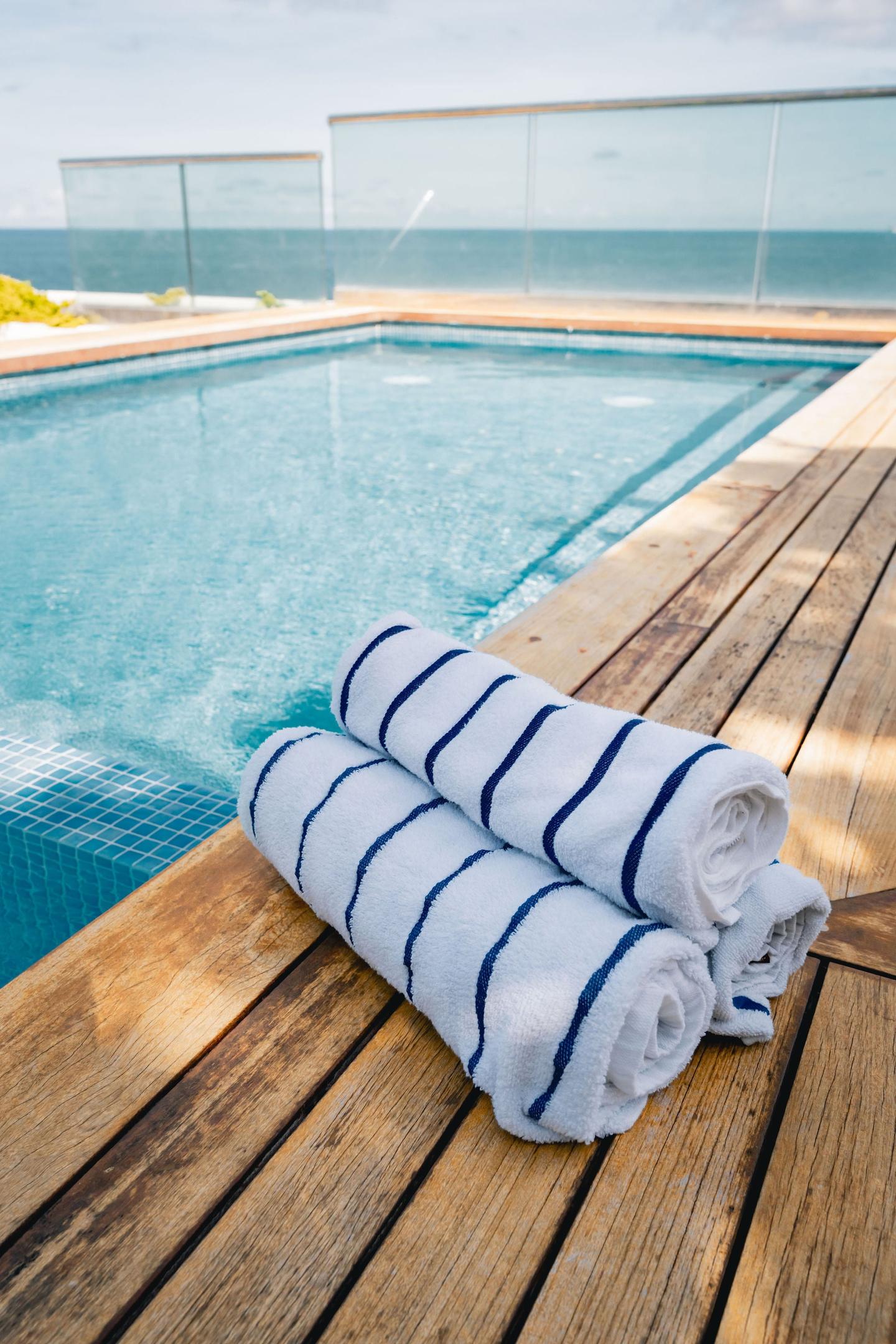 Resort towels styled poolside above the South Beach surf