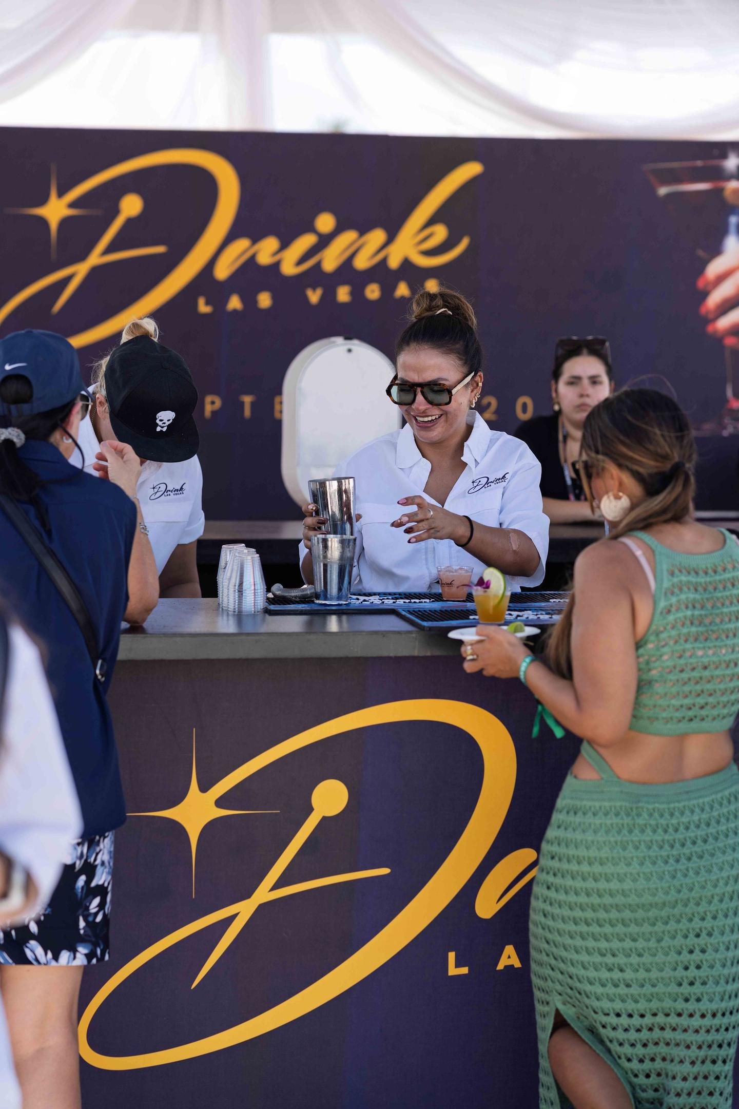 Drink Las Vegas booth team serving guests during live programming
